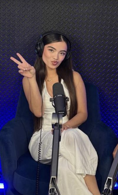 Recording video content in a podcast studio with a microphone and headphones